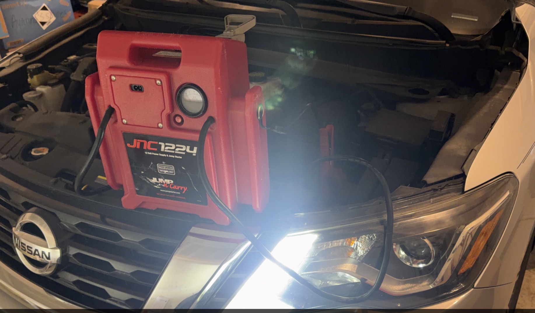 JNC1224 jump starter powering a Nissan back to life during a mobile jump start call